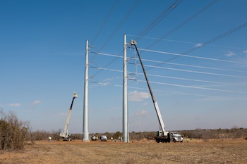 National Crane boom trucks construct high-voltage power line poles in the Texas panhandle.