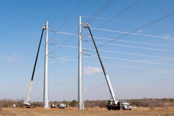 National Crane boom trucks construct high-voltage power line poles in the Texas panhandle.
